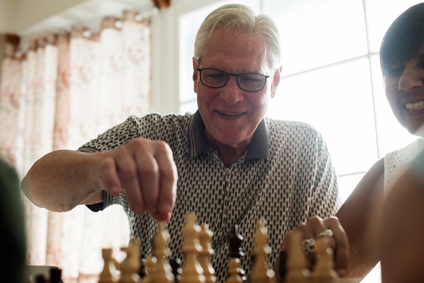 Senior friends playing chess together