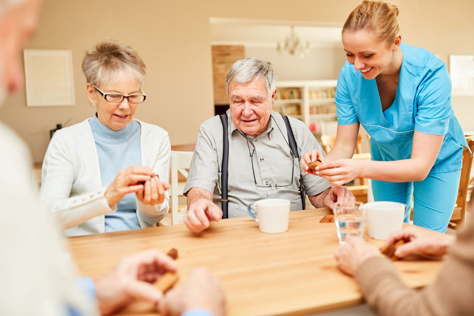 Nursing home care for seniors while drinking coffee and playing in the retirement home